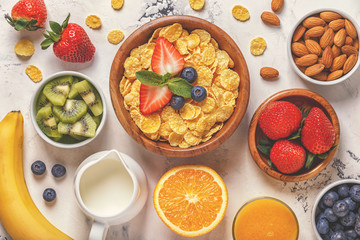 Healthy breakfast - bowl of corn flakes, berries and fruit © tbralnina