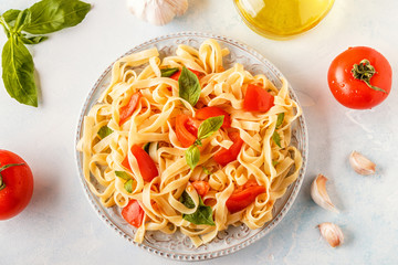 Pasta with tomato sauce served with basil