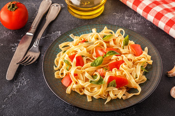 Pasta with tomato sauce served with basil