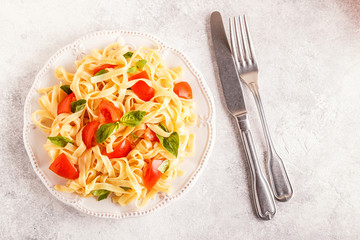 Pasta with tomato sauce served with basil