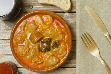 Spanish callos and ingredients on a white blackground