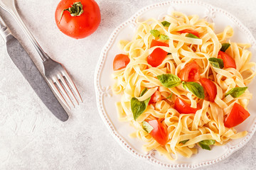 Pasta with tomato sauce served with basil