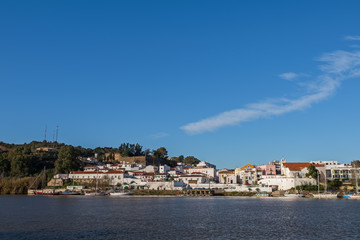 Naklejka na ściany i meble View of the Portuguese settlement of Alcoutim from the opposite bank of the Guadiana river - Spanish village Sanlucar de Guadiana