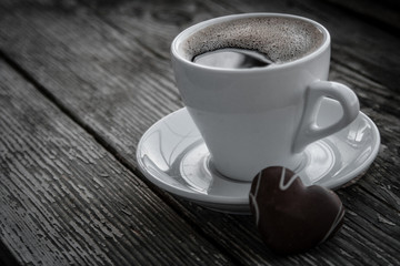 White cup of coffee on a natural old wooden background with biscuits. Selective focus. With copy space