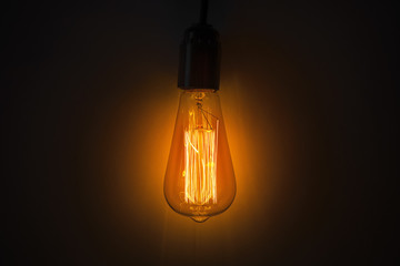 Old vintage edison bulb in the dark
