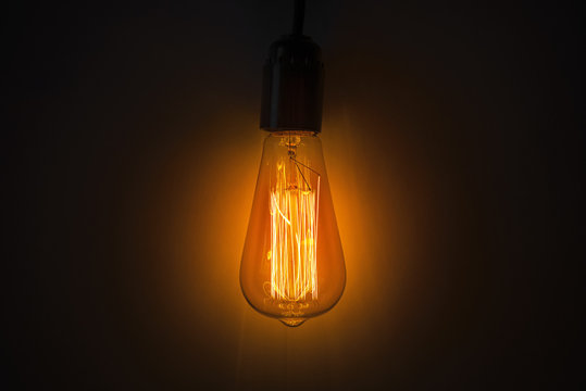 Old vintage edison bulb in the dark