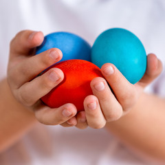 Easter. Painted eggs in the hands of a child. Photo closeup