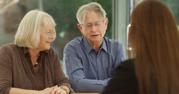 4K Senior couple reacting badly in a meeting with financial adviser. Slow motion