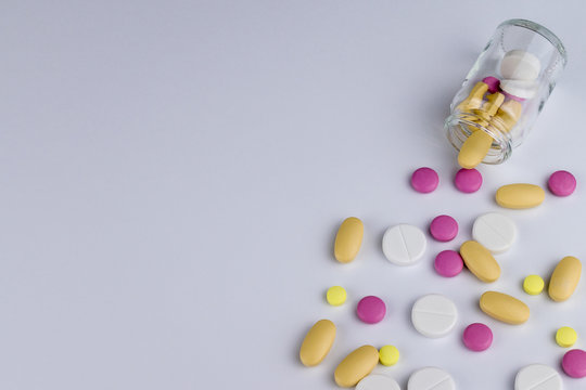 Bottle with pills on white background