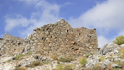 Fototapeta na wymiar Ruins of ancient Venetian windmills built in 15th century, Lassithi Plateau, Crete, Greece. Most typical characteristic of the Plateau. In the past, they numbered thousands making up a magnificent la
