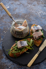 Herring sandwich (traditional Danish smorrebrod) on cutting board