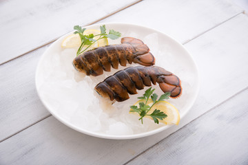 raw lobster tail on ice