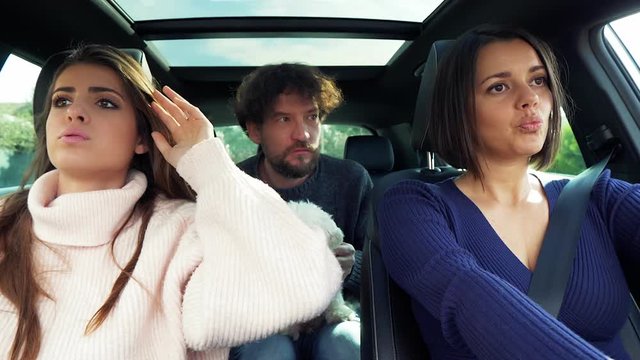 Woman driving car angry with boyfriend and girlfriend slow motion