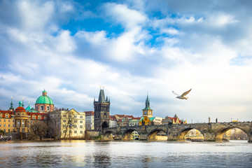 Cityscape of Prague with medieval towers and colorful buildings, famous Charles Bridge and tower, Czech Republic