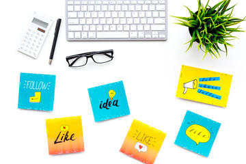 Digital marketing. Work desk of marketing specialist with social media icons and symbols on white background top view