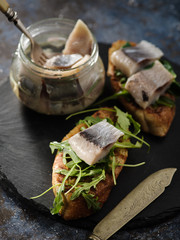 Herring sandwich (traditional Danish smorrebrod) on cutting board