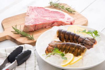 raw lobster tail and beef steak