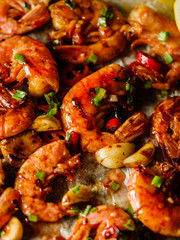 CLoseup of Large grilled BBQ shrimp with sweet chili sauce, green onion and lemon.