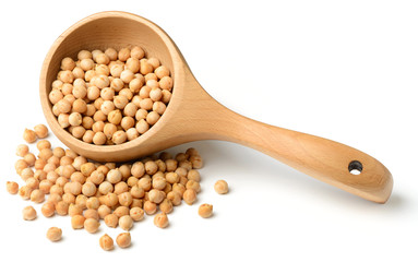 dried raw chickpeas in the wooden spoon, isolated on white