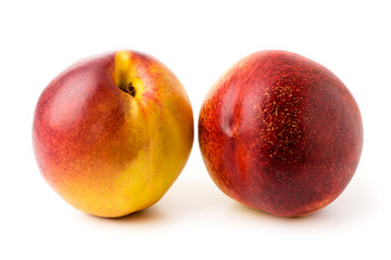 Two ripe peaches on a white, isolated.