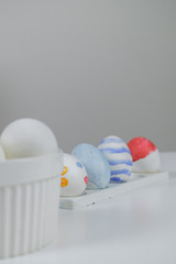 A table with white and colored eggs, prepared for decoration for Easter.