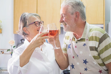 aged senior adult couple at home having fun in the kitchen
