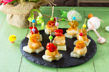 Easter recipe, festive appetizer. Canapes with pineapple, grill chicken, marinated peppers - on the...