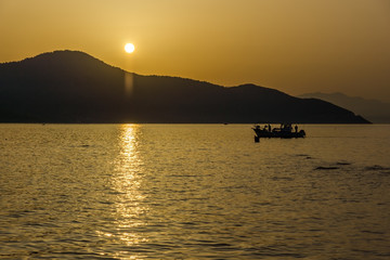 Fototapeta na wymiar Sunset view on embankment of Thassos town, East Macedonia and Thrace, Greece 
