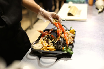 Chef preparing seafood platter for serving in restaurant