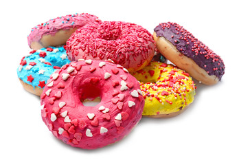 Delicious glazed doughnuts with sprinkles on white background