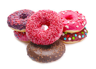 Delicious glazed doughnuts with sprinkles on white background