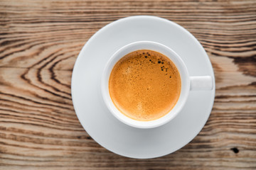 Coffee cup top view on wooden table background
