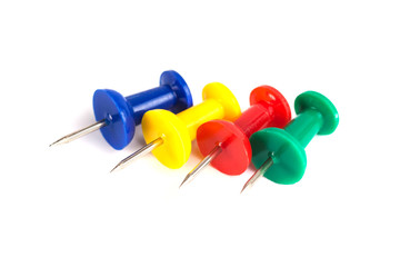 Closeup of Many Colored Thumbtacks on White