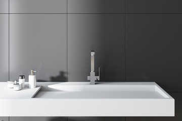Gray bathroom, white sink close up