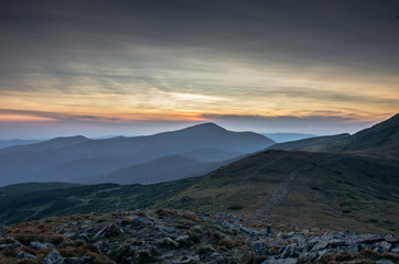 Evening sunset in the mountains. Leading path to the top.