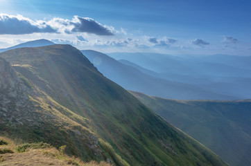 Mountain landscape and sun rays. Mountain ranges.