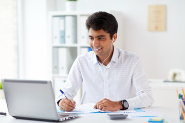 businessman in earphones working at office