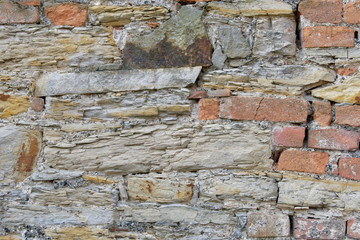 Old stone wall with scratches and cracks