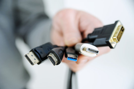 The  various cords and plugs in the hand.