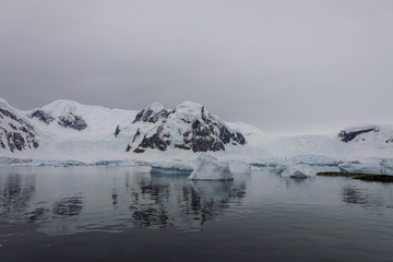 Fototapeta na wymiar Antarctic landscape with icebergs and reflection