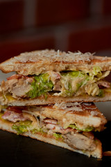 A delicious sandwich with salad and chicken. Sprinkled with cheese. A quick delicious Breakfast