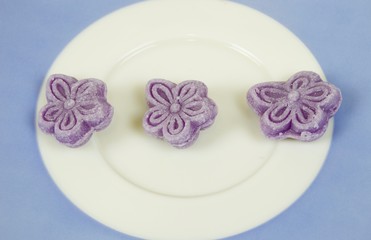 Violet candies isolated on white background