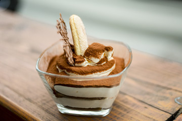 Traditional Italian dessert tiramisu decorated with cocoa 