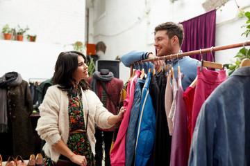 happy couple at vintage clothing store hanger