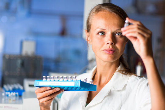 Portrait of a female researcher doing research in a lab (shallow DOF; color toned image)