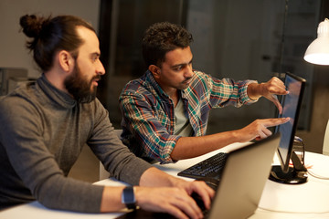 creative team with computer working late at office