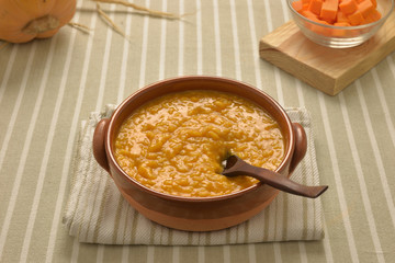 risotto with pumpkin in a crock bowl
