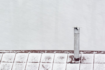 Falling snow and a small chimney.
