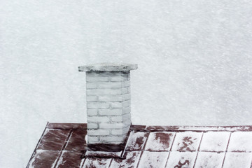 Falling snow and a blind chimney on a sheet metal roof.
