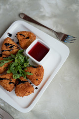 Camembert in batter, deep fried, with balsamic vinegar and arugula